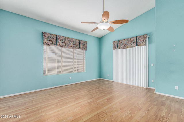 empty room featuring ceiling fan, light hardwood / wood-style floors, and lofted ceiling