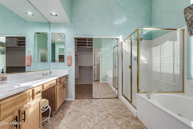 bathroom with tile patterned flooring, shower with separate bathtub, and vanity