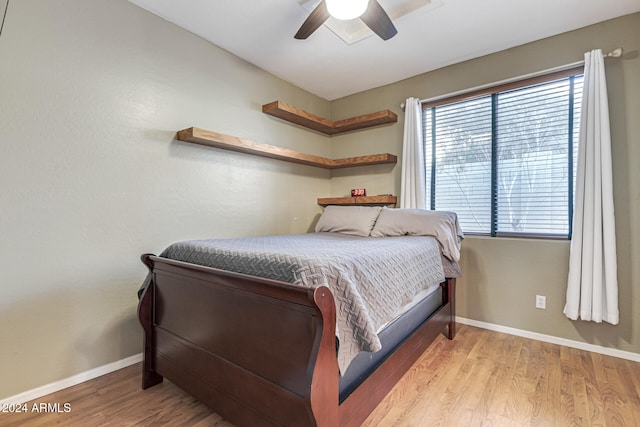 bedroom with ceiling fan and light wood-type flooring