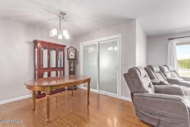 10448 W Caron Dr, Sun City, AZ 85351 - dining space with a chandelier, wood finished floors, and baseboards