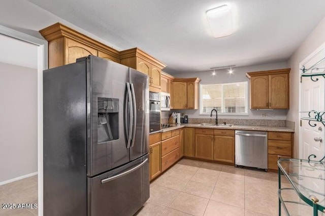10448 W Caron Dr, Sun City, AZ 85351 - kitchen with stainless steel appliances, a sink, and light tile patterned flooring