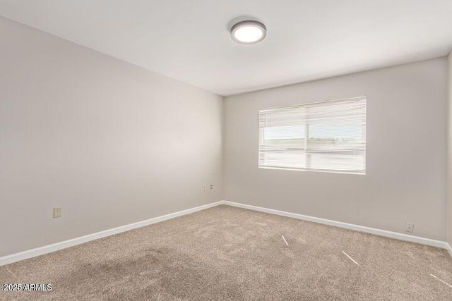 10448 W Caron Dr, Sun City, AZ 85351 - carpeted spare room featuring baseboards