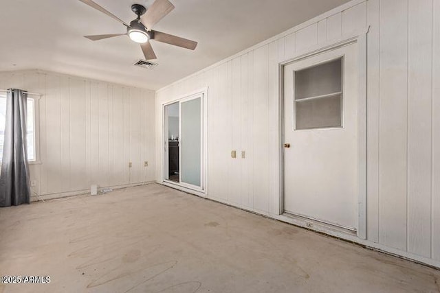 10448 W Caron Dr, Sun City, AZ 85351 - spare room with lofted ceiling, ceiling fan, and wooden walls