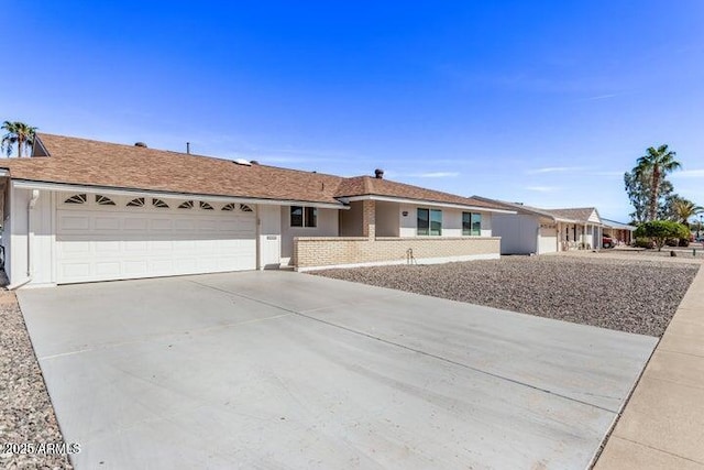 10448 W Caron Dr, Sun City, AZ 85351 - ranch-style home featuring an attached garage and concrete driveway