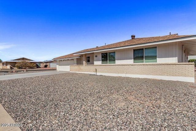 10448 W Caron Dr, Sun City, AZ 85351 - ranch-style home featuring brick siding, a garage, and driveway
