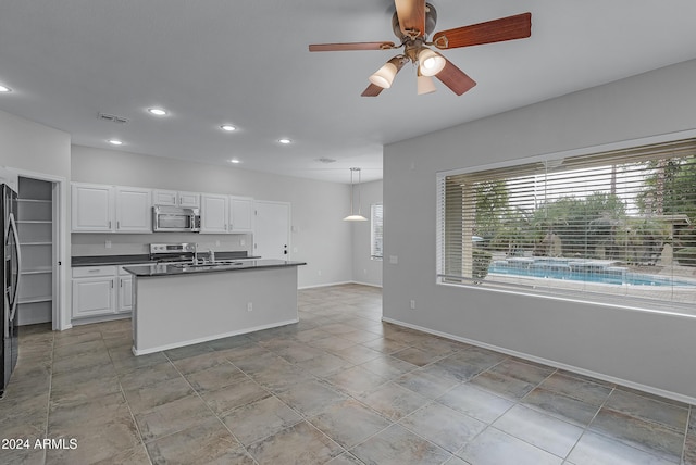 kitchen with white cabinetry, sink, ceiling fan, decorative light fixtures, and appliances with stainless steel finishes