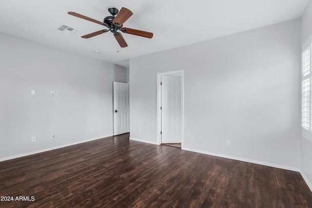 unfurnished room with ceiling fan and dark wood-type flooring