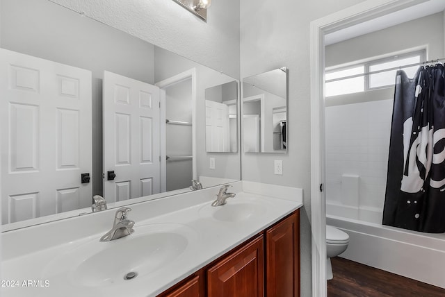 full bathroom with shower / tub combo, vanity, hardwood / wood-style flooring, and toilet