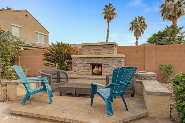 view of patio with an outdoor stone fireplace