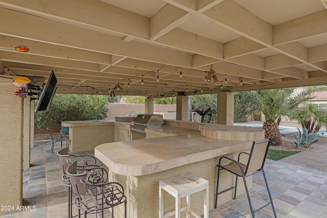 view of patio / terrace with exterior bar and grilling area