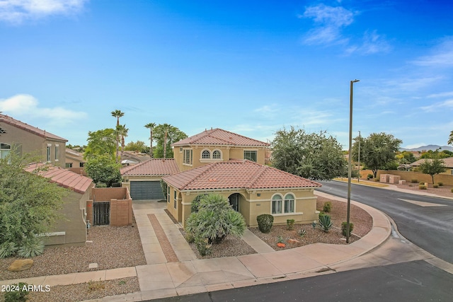 mediterranean / spanish-style home featuring a garage