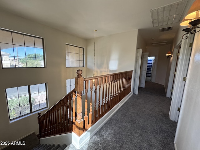 corridor with an upstairs landing, carpet, and visible vents