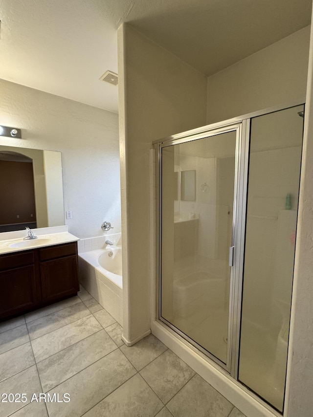 bathroom featuring visible vents, a bath, a shower stall, vanity, and tile patterned floors