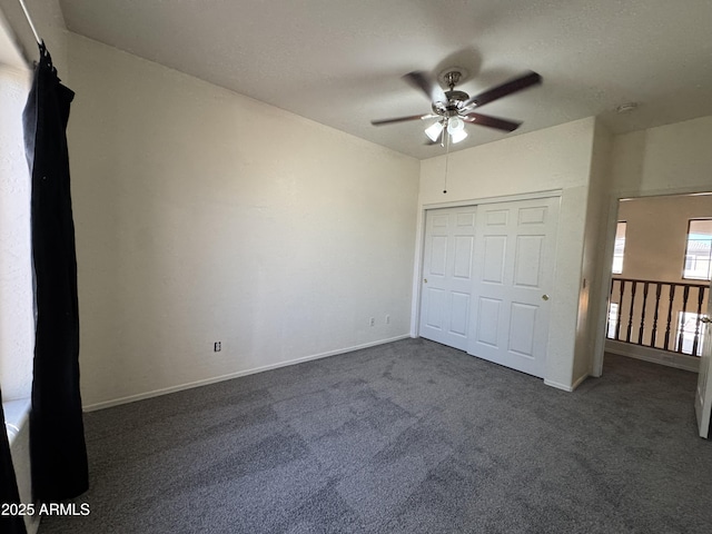unfurnished bedroom featuring a closet, baseboards, a ceiling fan, and carpet floors