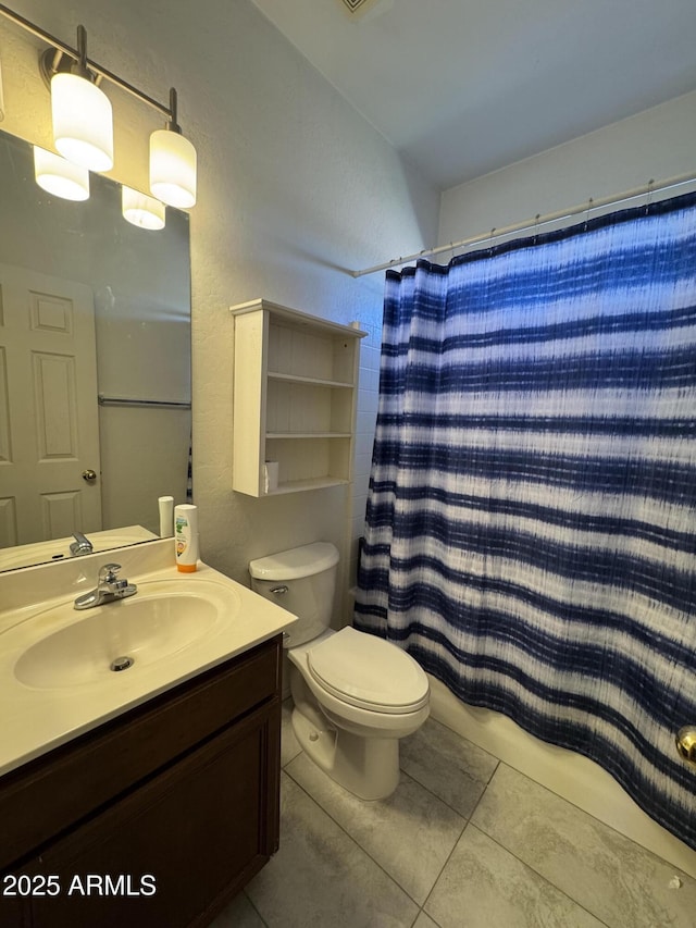 full bathroom with tile patterned floors, shower / tub combo with curtain, vanity, and toilet