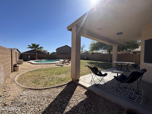view of yard featuring a fenced in pool, a patio, and a fenced backyard