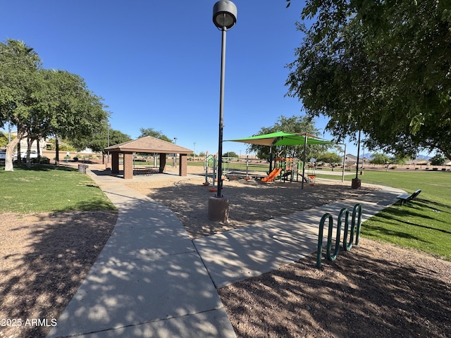 view of property's community with a yard, a gazebo, and playground community
