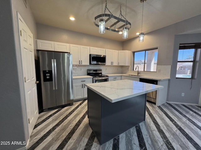kitchen featuring white cabinets, a sink, recessed lighting, stainless steel appliances, and backsplash