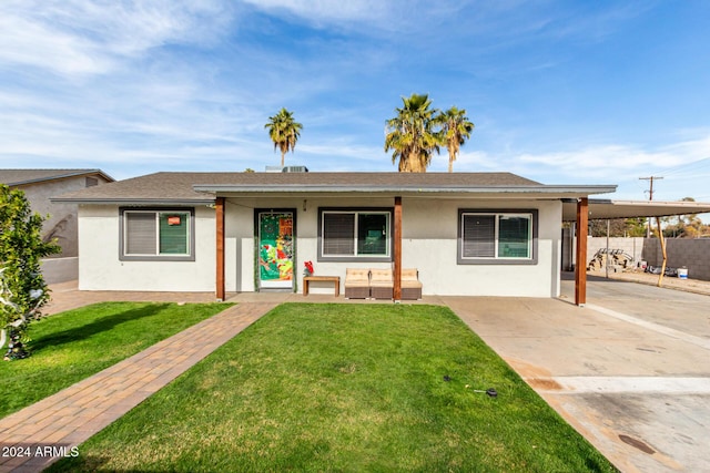 view of front facade with a front lawn and a carport