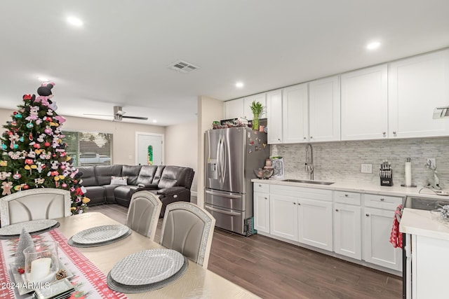 kitchen featuring dark wood-type flooring, sink, stainless steel refrigerator with ice dispenser, ceiling fan, and white cabinetry