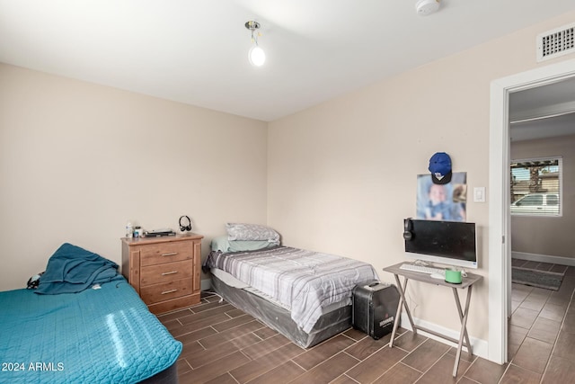 bedroom with dark hardwood / wood-style floors