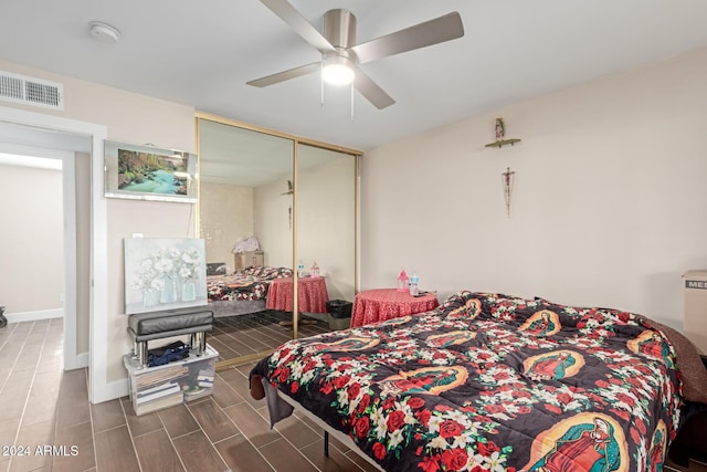 bedroom featuring a closet, dark wood-type flooring, and ceiling fan