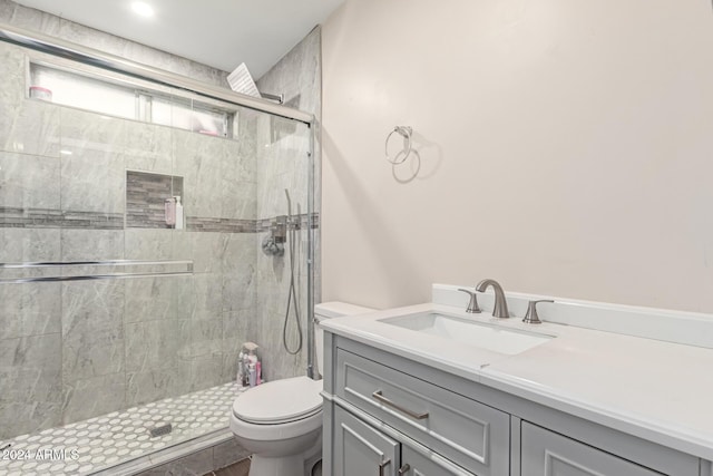 bathroom featuring vanity, toilet, and an enclosed shower