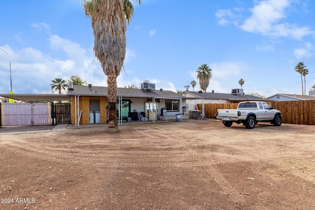 ranch-style house with a carport and cooling unit