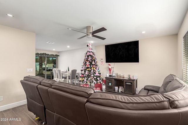 living room featuring wood-type flooring and ceiling fan