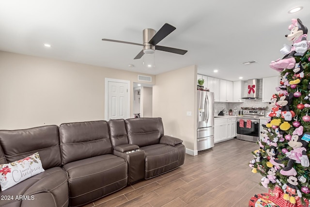 living room with hardwood / wood-style flooring and ceiling fan