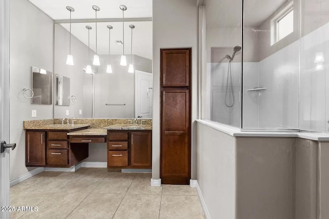 bathroom featuring a shower, tile patterned floors, and vanity