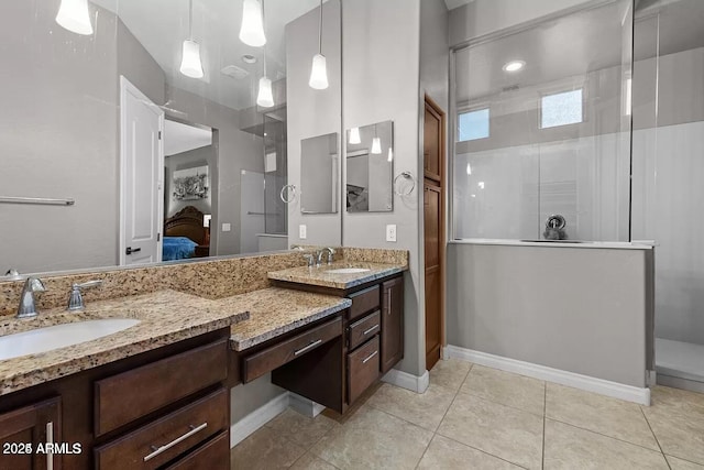 bathroom with tile patterned flooring, a shower, and vanity