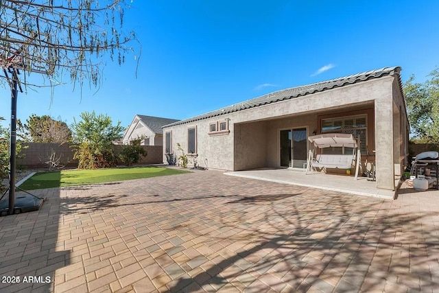 rear view of property featuring a patio