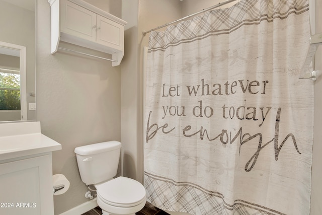 bathroom with vanity, a shower with shower curtain, and toilet