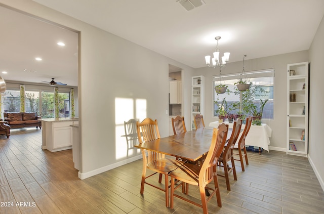 dining room with ceiling fan with notable chandelier