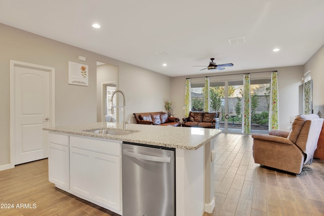 kitchen featuring stainless steel dishwasher, ceiling fan, sink, a center island with sink, and white cabinets