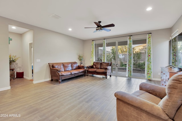 living room with ceiling fan and light hardwood / wood-style floors