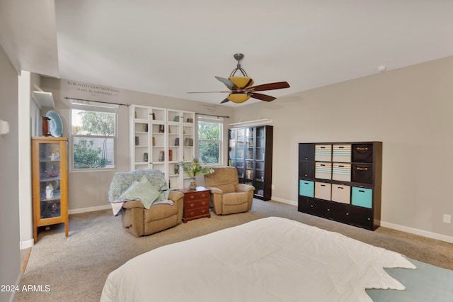 carpeted bedroom with ceiling fan and multiple windows