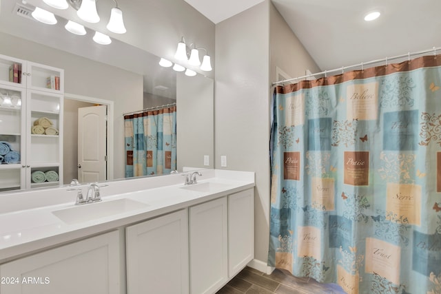 bathroom featuring a shower with shower curtain and vanity