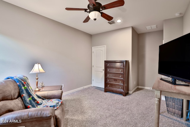 living area with carpet flooring and ceiling fan