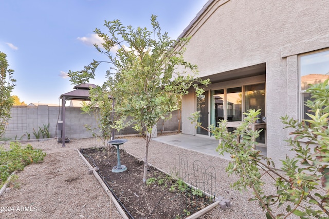 view of yard featuring a gazebo and a patio area