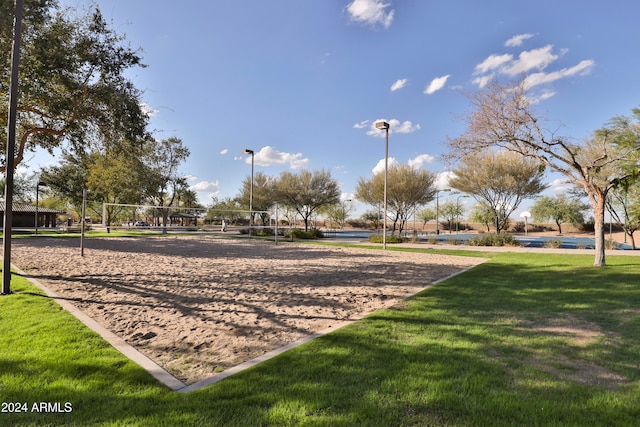 view of community featuring volleyball court and a yard