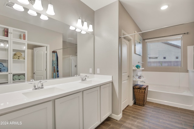 bathroom featuring vanity and shower with separate bathtub