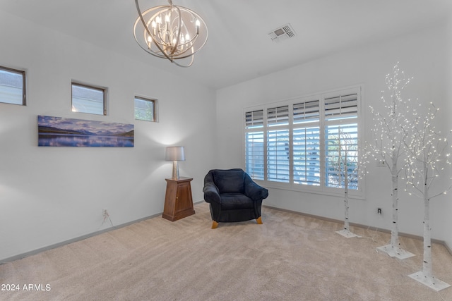 living area featuring light carpet and a notable chandelier