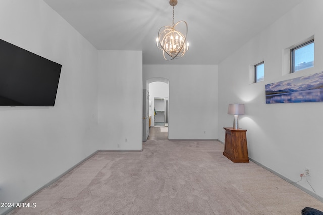 interior space with light colored carpet and a notable chandelier