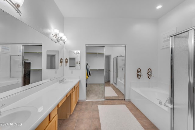 bathroom with independent shower and bath, tile patterned floors, and vanity