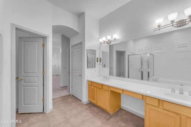 bathroom featuring vanity, tile patterned flooring, and a shower with door