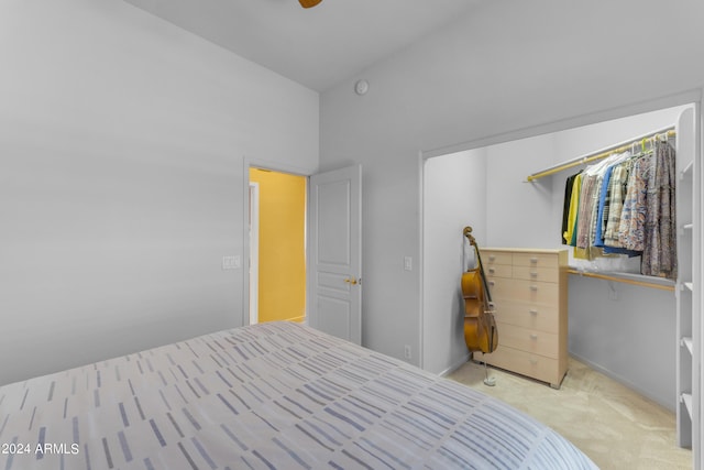 unfurnished bedroom featuring a high ceiling, light colored carpet, and a closet