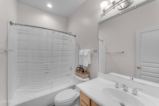 full bathroom with toilet, vanity, and shower / tub combo