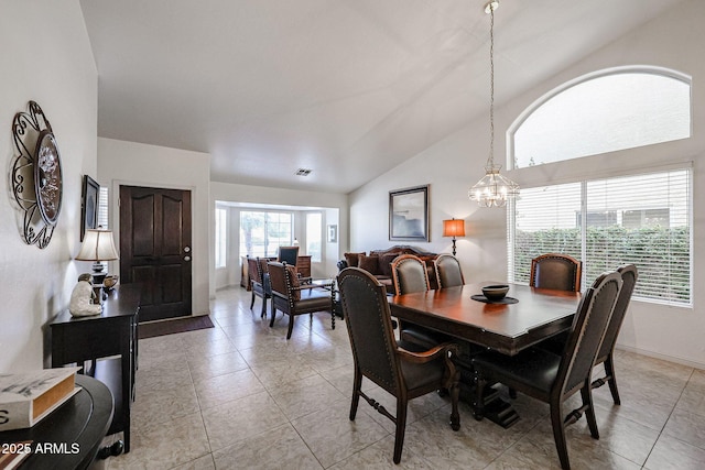 dining room featuring visible vents, baseboards, a chandelier, vaulted ceiling, and light tile patterned floors